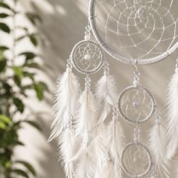 Detaljebillede af h�ndlavet hvid dr�mmefanger med Capiz-skaller, hvide fjer og dekorative perler med regnbuesk�r.